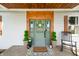 Charming front door with wooden trim, wreath, potted plants, and welcome mat at 4622 W 400 S, Trafalgar, IN 46181