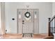 White front door with decorative glass, wreath, and a horseshoe overhead at 4622 W 400 S, Trafalgar, IN 46181