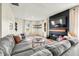 Bright living room with a modern fireplace, large sectional couch, and wood floors at 4622 W 400 S, Trafalgar, IN 46181