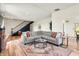 Bright and airy living area with a gray sectional sofa and stylish decorative rug at 4622 W 400 S, Trafalgar, IN 46181