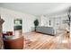 Spacious living room with wood floors, a cozy seating area, and natural light at 4622 W 400 S, Trafalgar, IN 46181
