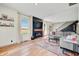 Comfortable living room with a modern fireplace, large windows, and open staircase at 4622 W 400 S, Trafalgar, IN 46181