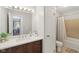 Bathroom boasts a dark wood vanity, a modern sink, and a bath with shower at 4708 Dorkin Ct, Indianapolis, IN 46254