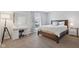 Comfortable bedroom features a window, wood bed frame, and desk at 4708 Dorkin Ct, Indianapolis, IN 46254