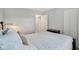 Bedroom features neutral walls, carpet, and a bed with blue and white duvet at 4708 Dorkin Ct, Indianapolis, IN 46254