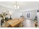 Airy dining room featuring a large table, decorative lighting, and a view of the backyard at 4708 Dorkin Ct, Indianapolis, IN 46254