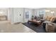 Well-lit living area with a stylish sofa, decorative rug, and easy access to the front entrance at 4708 Dorkin Ct, Indianapolis, IN 46254