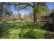 The spacious backyard features mature trees, lush lawn and a nice patio area at 4710 E 56Th St, Indianapolis, IN 46220