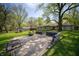 Spacious backyard with patio, lush lawn, mature trees, and outbuilding/shed at 4710 E 56Th St, Indianapolis, IN 46220