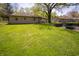 Backyard featuring a nice lawn, patio, mature trees, and neighboring houses at 4710 E 56Th St, Indianapolis, IN 46220