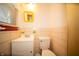 This bathroom features a white toilet and vanity with a mirror, all accented by unique yellow trim at 4710 E 56Th St, Indianapolis, IN 46220