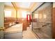 This bathroom features tile walls, glass shower stall with a seat, and a sink with vanity mirror at 4710 E 56Th St, Indianapolis, IN 46220