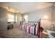 Comfortable bedroom with stylish lighting, desk area, and large window for natural light at 4710 E 56Th St, Indianapolis, IN 46220