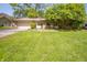 Charming single-story home with a well-maintained lawn, mature tree, and attached two-car garage at 4710 E 56Th St, Indianapolis, IN 46220