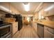 Full kitchen view to the eating area with hardwood floors and neutral cabinets at 4710 E 56Th St, Indianapolis, IN 46220