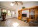 Comfortable living room features a ceiling fan, and a large entertainment center for storage and media display at 4710 E 56Th St, Indianapolis, IN 46220
