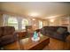Cozy living room featuring a wood coffee table, comfortable seating, hardwood floors, and neutral paint at 4710 E 56Th St, Indianapolis, IN 46220