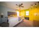 Bright main bedroom features a queen bed, ceiling fan, and yellow built in closet and drawer space at 4710 E 56Th St, Indianapolis, IN 46220