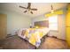 This main bedroom features a queen bed, ceiling fan, and bright yellow closet and drawer space at 4710 E 56Th St, Indianapolis, IN 46220