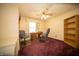 This home office features a ceiling fan, desk, and office chairs, ideal for working from home at 4710 E 56Th St, Indianapolis, IN 46220