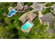 Overhead shot showing a pristine swimming pool amidst lush greenery, providing a perfect backyard oasis for relaxation and entertainment at 4731 Moss Creek Ct, Indianapolis, IN 46237