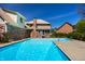 Lush backyard with a sparkling in-ground pool with trees and blue skies at 4731 Moss Creek Ct, Indianapolis, IN 46237