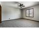 Bright, carpeted bedroom, featuring a window view and a ceiling fan at 4731 Moss Creek Ct, Indianapolis, IN 46237
