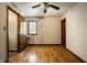 Bedroom with hardwood floors, two doors, and natural light from window at 4731 Moss Creek Ct, Indianapolis, IN 46237
