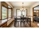 Dining room with wood trim and large bay window between the kitchen and living room at 4731 Moss Creek Ct, Indianapolis, IN 46237