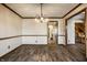 Open dining room featuring hardwood floors, classic trim, and a chandelier at 4731 Moss Creek Ct, Indianapolis, IN 46237