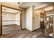 Hallway leading to dining room and foyer, showcasing hardwood floors and warm lighting at 4731 Moss Creek Ct, Indianapolis, IN 46237