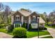 Beautiful brick home featuring lush green lawn and mature trees enhancing the property's appeal at 4731 Moss Creek Ct, Indianapolis, IN 46237