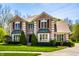 Stunning brick home featuring manicured landscaping, enhancing its curb appeal and charm at 4731 Moss Creek Ct, Indianapolis, IN 46237