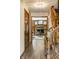 Hallway with wooden staircase showcasing detailed banister and views into a living room with brick fireplace at 4731 Moss Creek Ct, Indianapolis, IN 46237
