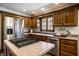Eat-in kitchen with stainless steel appliances, wood cabinets and a kitchen window above the sink at 4731 Moss Creek Ct, Indianapolis, IN 46237