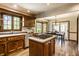 Spacious kitchen featuring a center island with cooktop, wood cabinetry, and a charming breakfast nook at 4731 Moss Creek Ct, Indianapolis, IN 46237