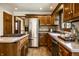Eat-in kitchen with stainless steel appliances, wood cabinets and cooktop island at 4731 Moss Creek Ct, Indianapolis, IN 46237
