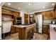 Eat-in kitchen with stainless steel appliances, wooden cabinets, and a center island with cooktop at 4731 Moss Creek Ct, Indianapolis, IN 46237
