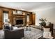 Comfortable living room with wood paneling, brick fireplace, and stylish seating arrangement at 4731 Moss Creek Ct, Indianapolis, IN 46237