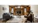 Cozy living room with wood paneling, brick fireplace, and stylish furnishings for a comfortable setting at 4731 Moss Creek Ct, Indianapolis, IN 46237