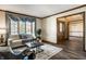 Bright living room featuring a white sofa, stylish rug, and ample natural light through a large window at 4731 Moss Creek Ct, Indianapolis, IN 46237