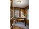 Cozy office with rich wood paneling, bright windows, and a comfortable seating area, perfect for work or study at 4731 Moss Creek Ct, Indianapolis, IN 46237