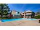 A pristine backyard pool features cool, crystal-clear water, with a brick home in the background under a clear blue sky at 4731 Moss Creek Ct, Indianapolis, IN 46237