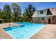 Beautiful pool with patio area, landscaping, and the home in background at 4731 Moss Creek Ct, Indianapolis, IN 46237