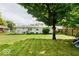 Expansive backyard with lush green grass and mature trees offering shade; perfect for outdoor activities and relaxation at , Indianapolis, IN 46226