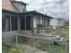 Enclosed back porch with screens and a small deck, enclosed by a chain link fence at 518 N Grant St, Lebanon, IN 46052