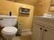 Compact bathroom with a standard toilet, white vanity, and simple decor for essential needs at 518 N Grant St, Lebanon, IN 46052