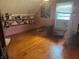Unique bedroom featuring hardwood floors, pink walls, shelves, and an abundance of collectible dolls at 518 N Grant St, Lebanon, IN 46052