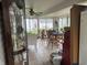 Enclosed porch with tile flooring, a ceiling fan, and multiple windows at 518 N Grant St, Lebanon, IN 46052
