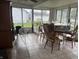 Enclosed porch with tile flooring, a ceiling fan, and multiple windows at 518 N Grant St, Lebanon, IN 46052